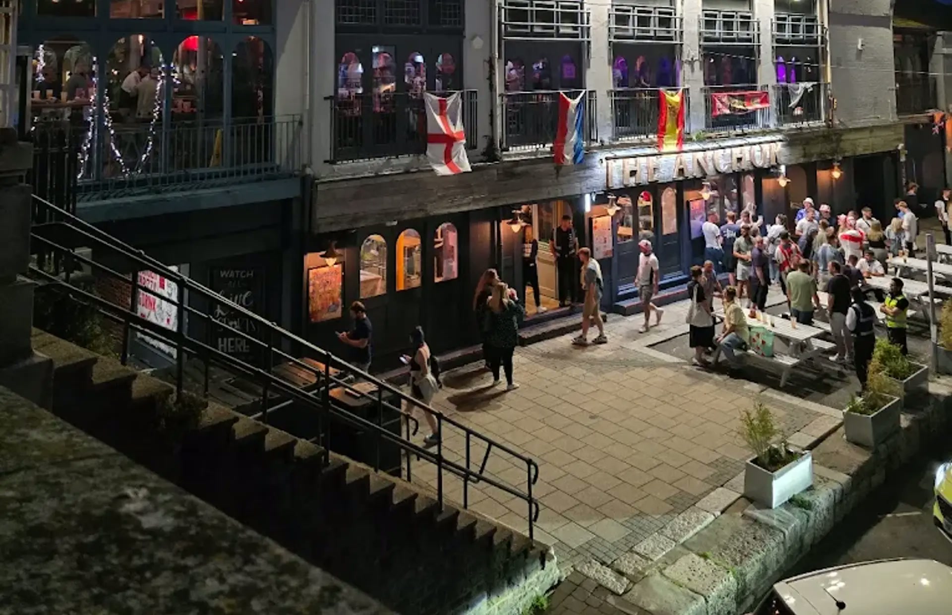 Rendezvous Weymouth at night — the three-storey venue on St Thomas Street beside the harbour, with the illuminated sign and entrance terrace